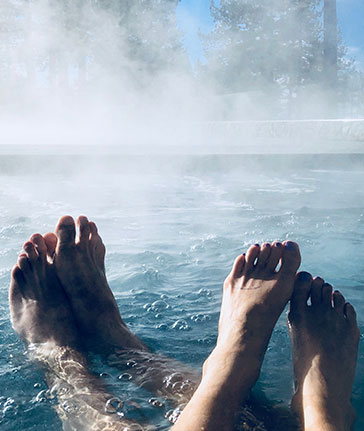 man and woman feet in spa